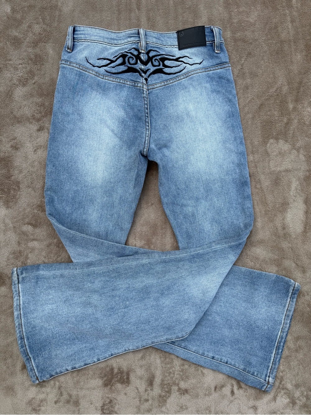 Austin Landing tribal tattoo y2k flare jeans